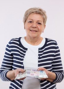 Happy senior female counting polish money, concept of financial security